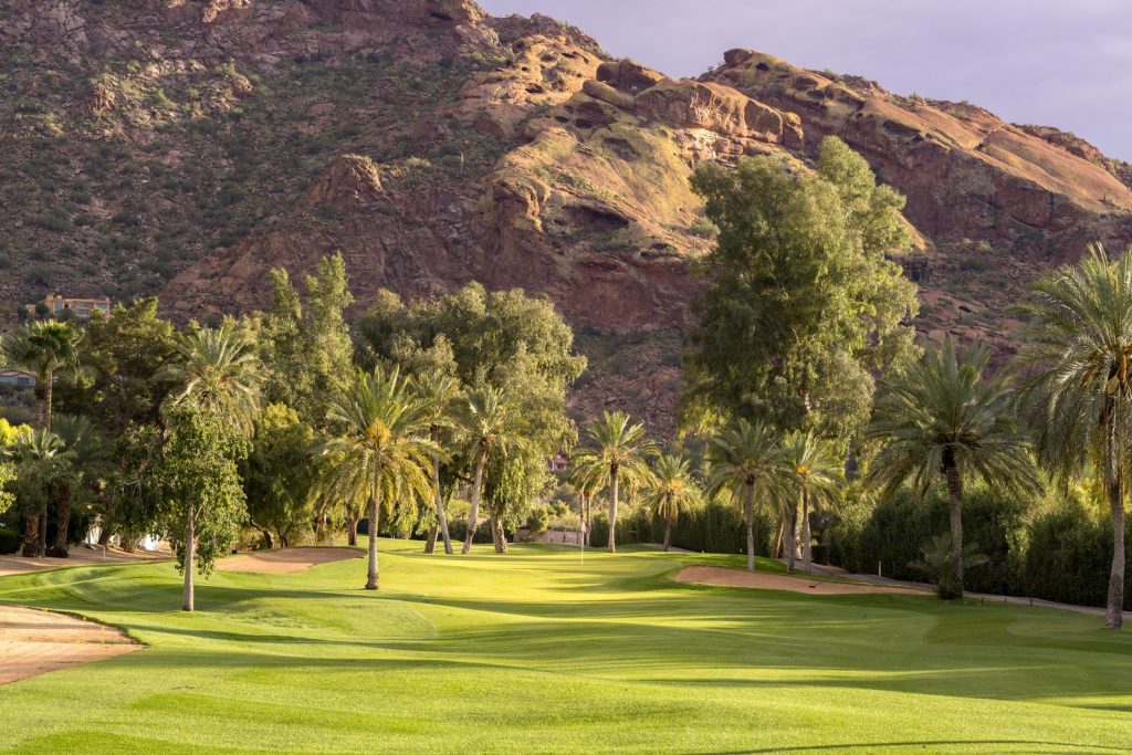 golf course with many trees and mountains